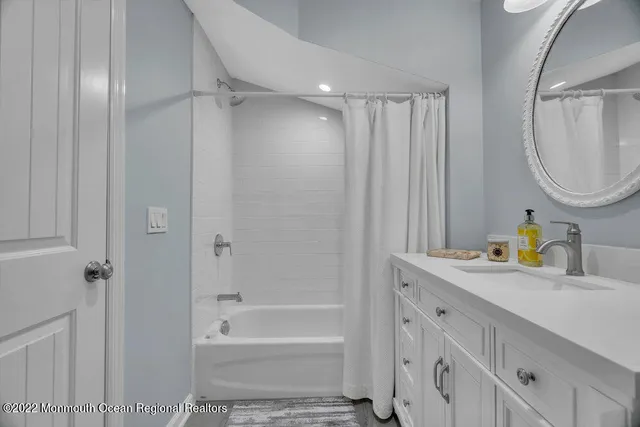 a bedroom with two beds and a window