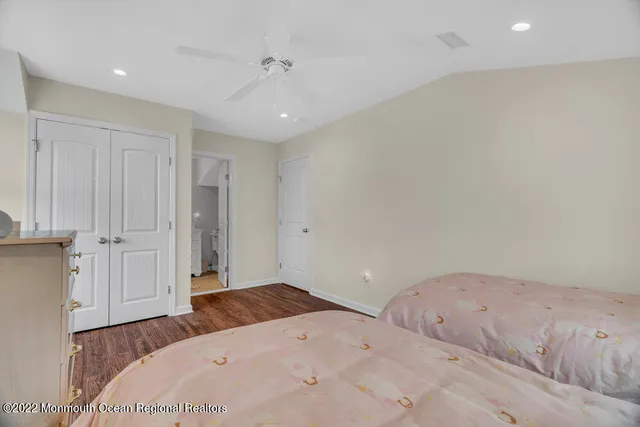 a spacious bedroom with two beds and a dresser