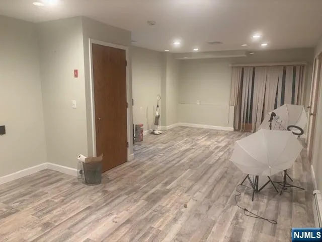 a view of a room with wooden floor and bench