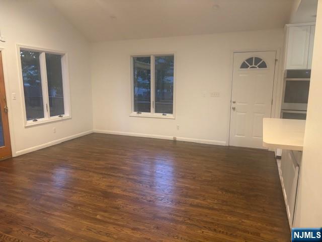 992 Ridge Court New Milford, NJ 07646 - Photo 5 of 15 a view of an empty room with wooden floor and a window