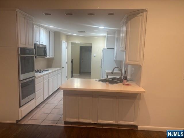 992 Ridge Court New Milford, NJ 07646 - Photo 6 of 15 a bathroom with a sink and a mirror
