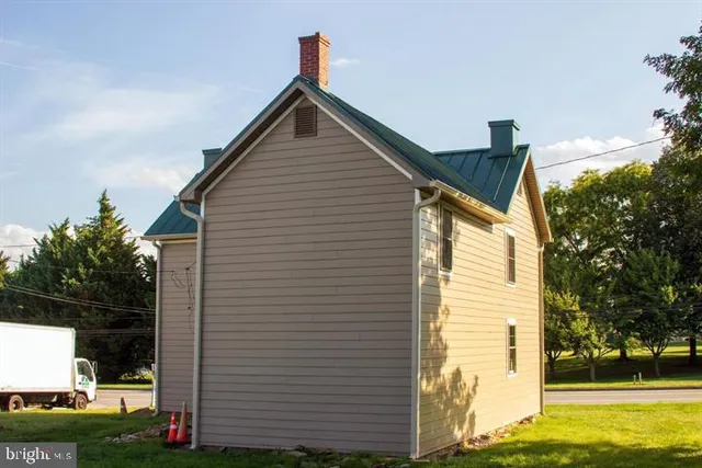 a view of house with backyard