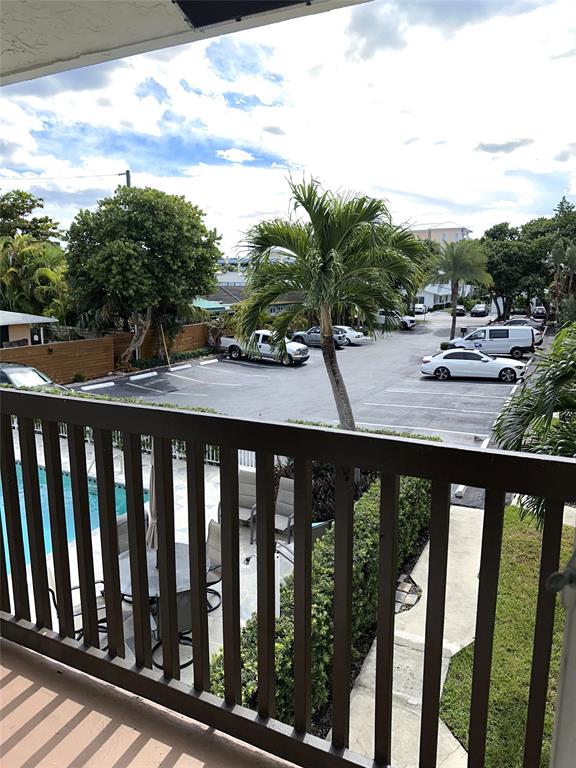1917 Northeast 3rd Street, Unit 113 Deerfield Beach, FL 33441 - Photo 11 of 23 a view of a balcony with wooden floor and outdoor space
