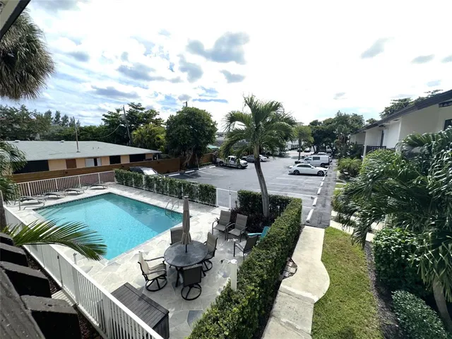 a bathroom with a sink a toilet a mirror and shower