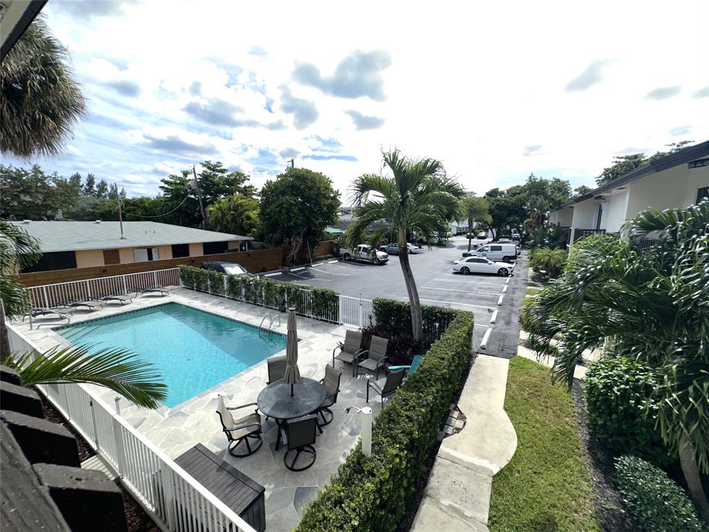 1917 Northeast 3rd Street, Unit 113 Deerfield Beach, FL 33441 - Photo 12 of 23 an aerial view of a house with swimming pool and lake view