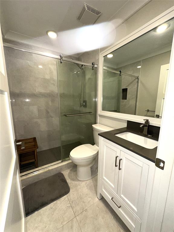1917 Northeast 3rd Street, Unit 113 Deerfield Beach, FL 33441 - Photo 13 of 23 a bathroom with a sink a toilet a mirror and shower