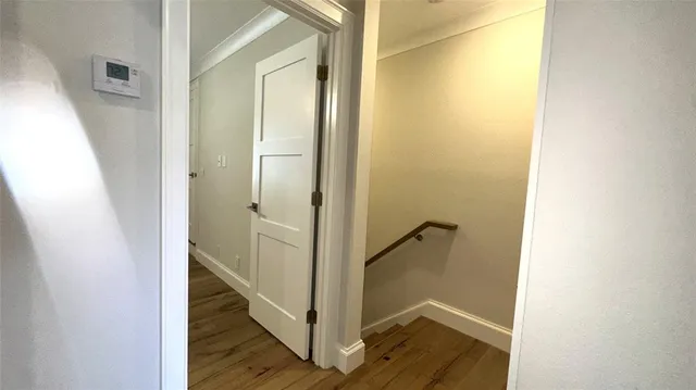 a view of a room with wooden floor