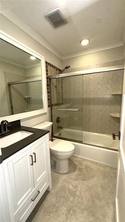 1917 Northeast 3rd Street, Unit 113 Deerfield Beach, FL 33441 - Photo 17 of 23 a bathroom with a toilet a sink and shower