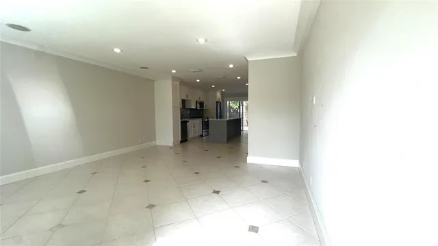 a view of an empty room and a window