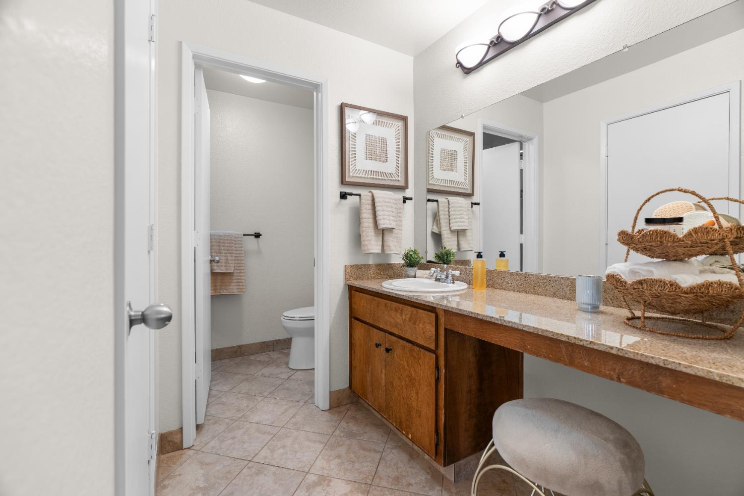 2401 Eilers Lane, Unit 105 Lodi, CA 95242 - Photo 12 of 23 a spacious bathroom with a granite countertop sink a toilet and a mirror
