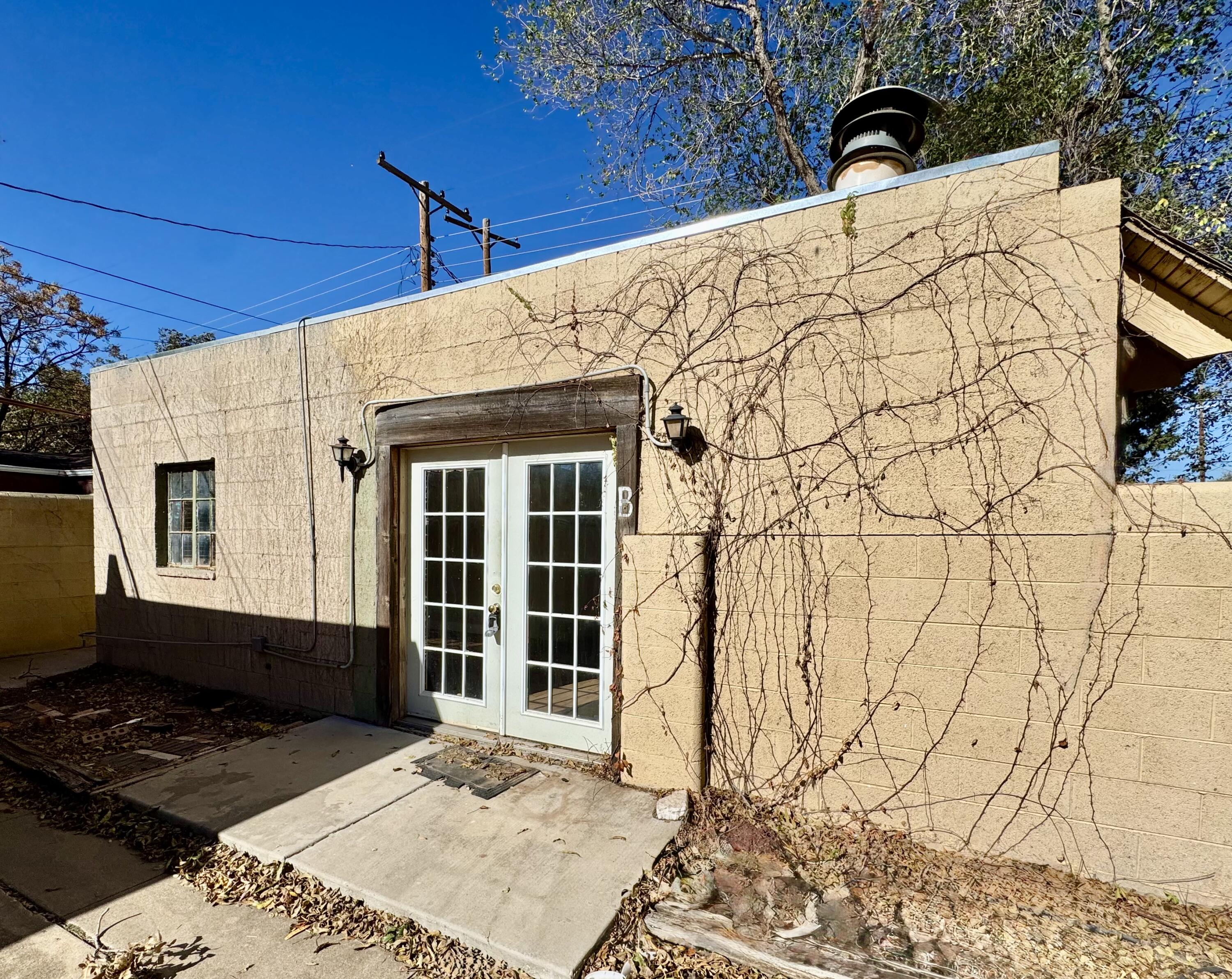 2702 23rd Street, Unit B Lubbock, TX 79410 - Photo 1 of 9 a front view of a house with a yard
