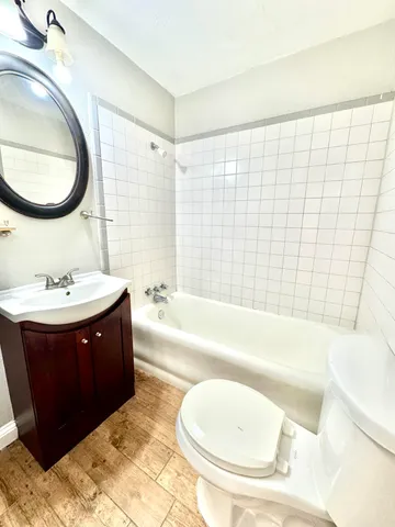a bathroom with a bathtub a sink and a mirror