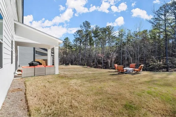 a view of a house with backyard and sitting area