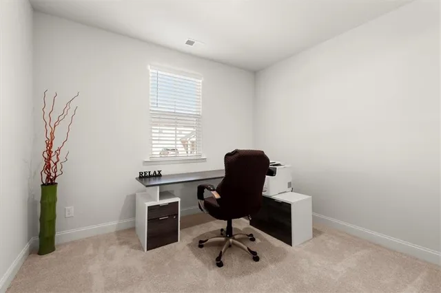 a view of a workspace with furniture
