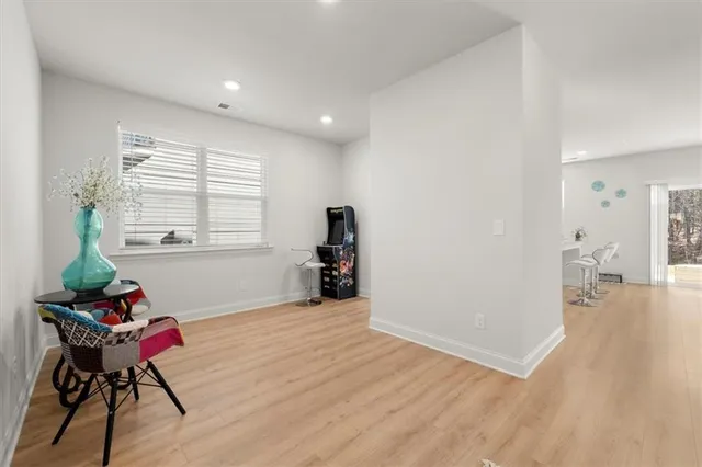 a living room with furniture and wooden floor