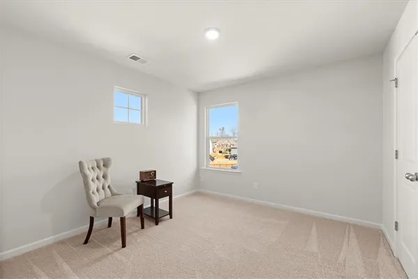 a view of a room with furniture and window