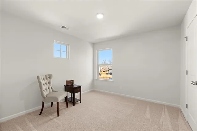 a view of a room with furniture and window