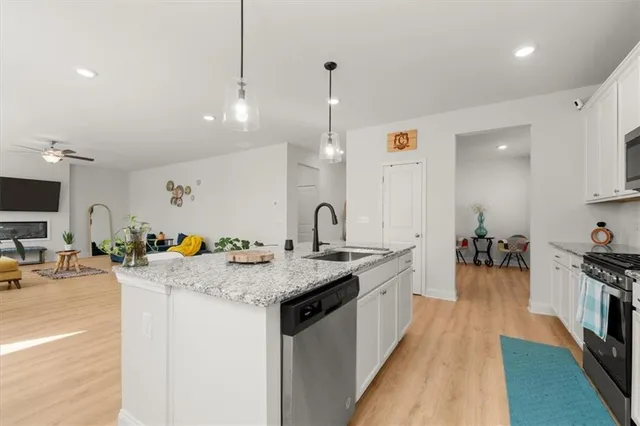 a kitchen with sink a stove and cabinets