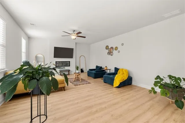 a living room with furniture flowerpot and a potted plant
