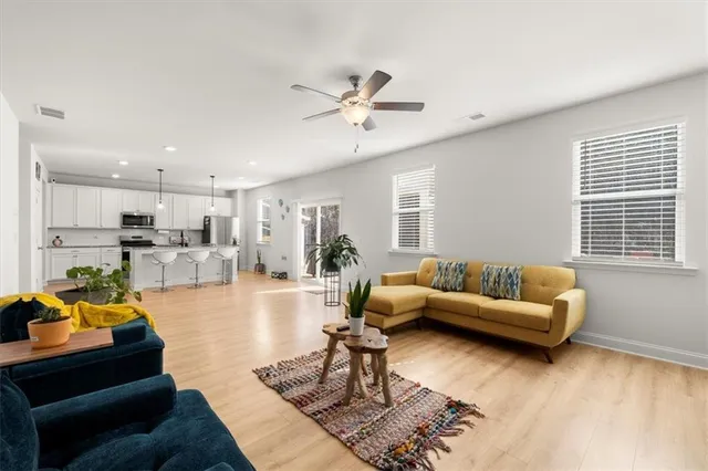 a living room with furniture and kitchen view
