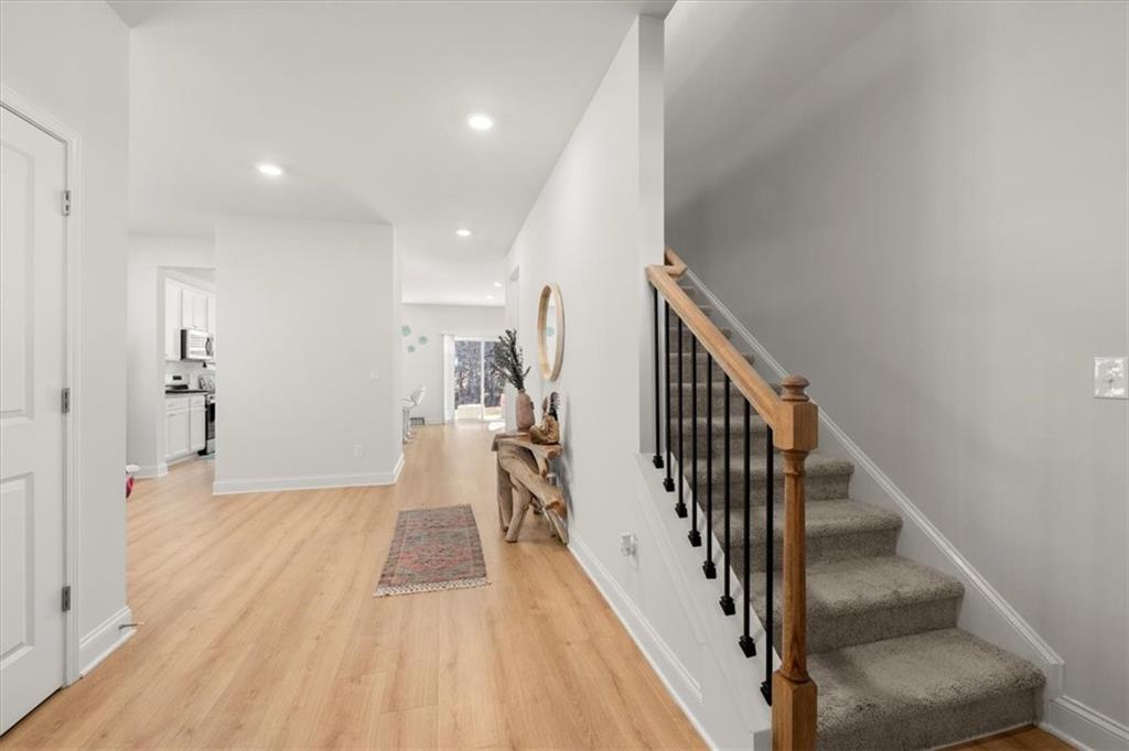 29 Dew Drop Pointe Dallas, GA 30157 - Photo 31 of 41 a view of a hallway with wooden floor and staircase