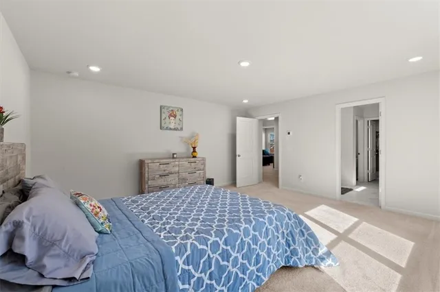 a en suite bathroom with a double vanity sink a mirror and shower