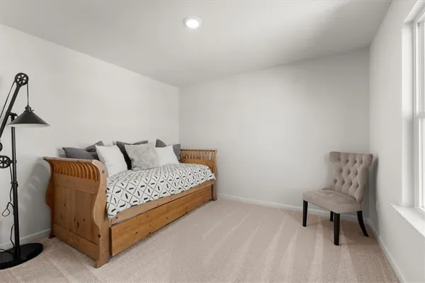 a bedroom with a bed and a night stand