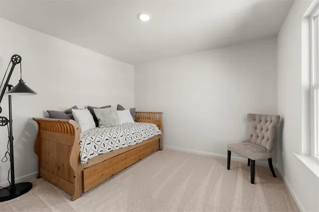 a bedroom with a bed and a night stand