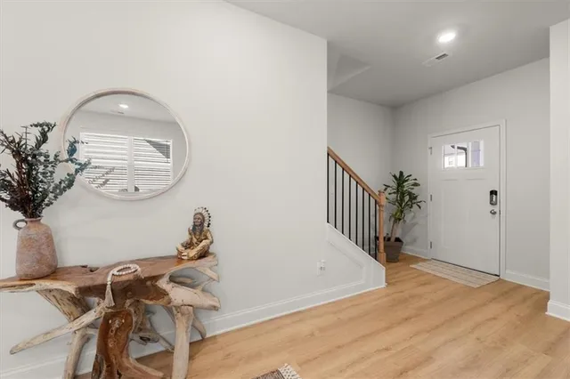 a view of a room with wooden floor fan and windows