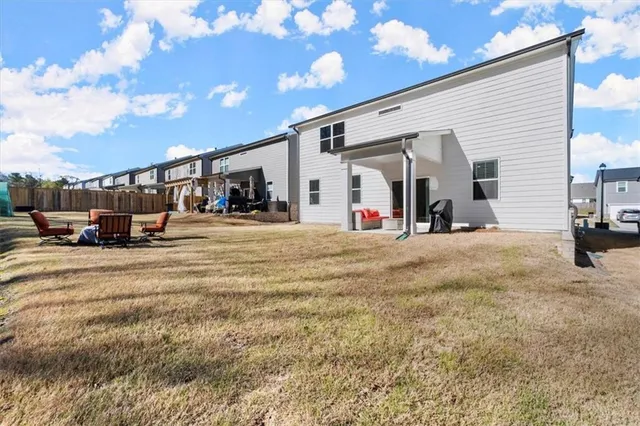 a view of a house with cars park
