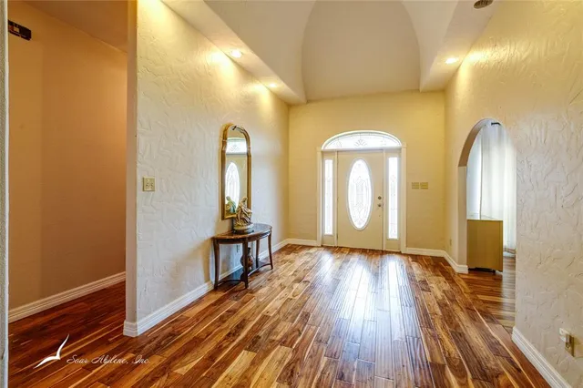 a view of a room with wooden floor and windows