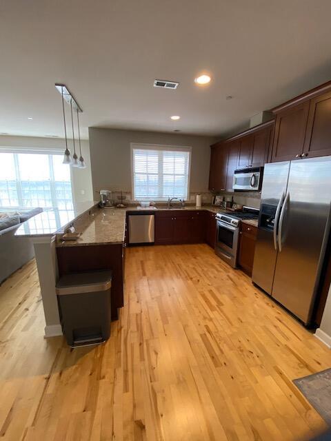 50 North Plum Grove Road, Unit 405 Palatine, IL 60067 - Photo 4 of 14 a large kitchen with kitchen island granite countertop a sink and a stove top oven