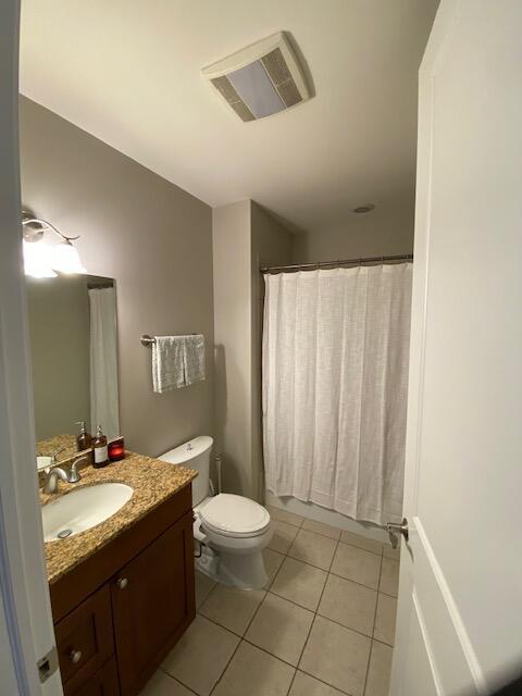 50 North Plum Grove Road, Unit 405 Palatine, IL 60067 - Photo 8 of 14 a bathroom with a granite countertop sink a toilet and a mirror