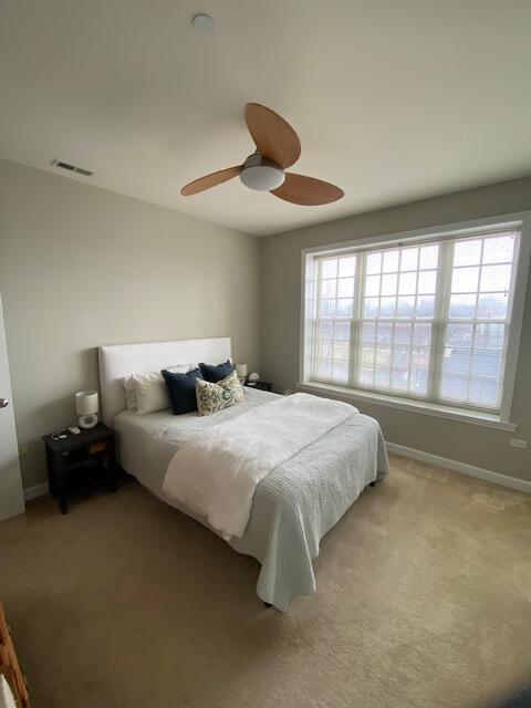 50 North Plum Grove Road, Unit 405 Palatine, IL 60067 - Photo 10 of 14 a spacious bedroom with a bed and a large window