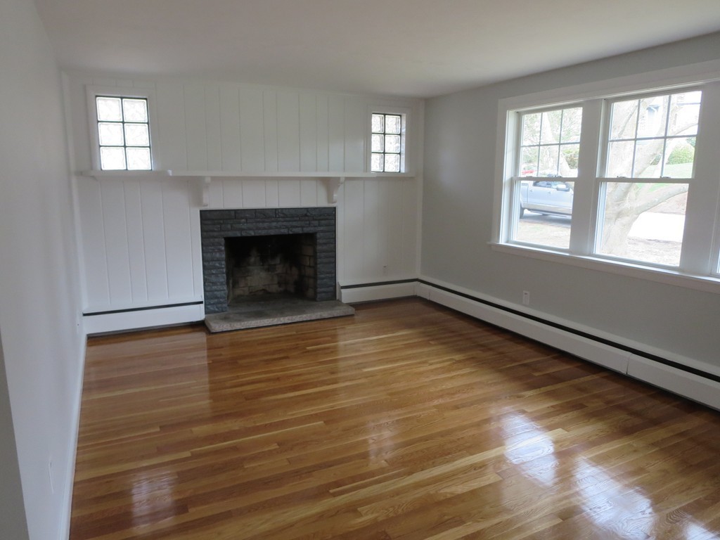 23 Lohnes Road Framingham, MA 01701 - Photo 8 of 26 wooden floor fireplace and windows in an empty room