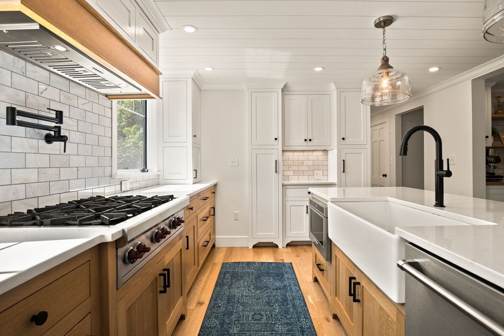 1 True Road Salisbury, MA 01952 - Photo 18 of 41 a kitchen with stainless steel appliances granite countertop a sink stove and cabinets