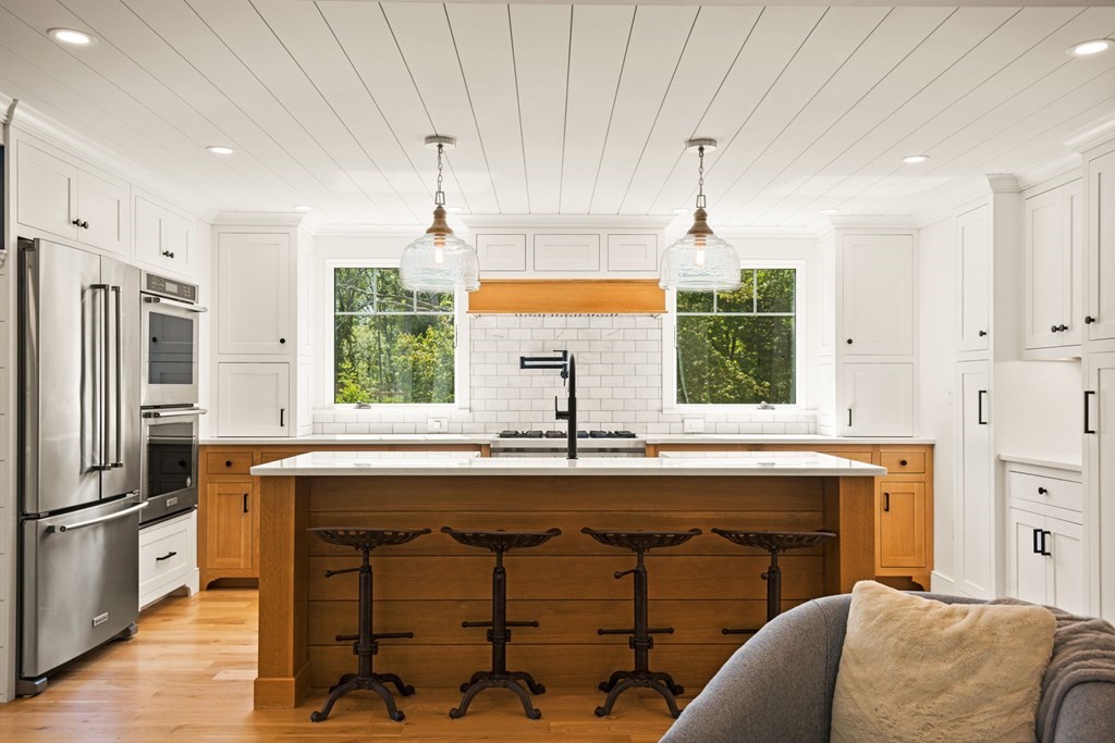 1 True Road Salisbury, MA 01952 - Photo 19 of 41 a kitchen with kitchen island granite countertop a stove a sink and a refrigerator