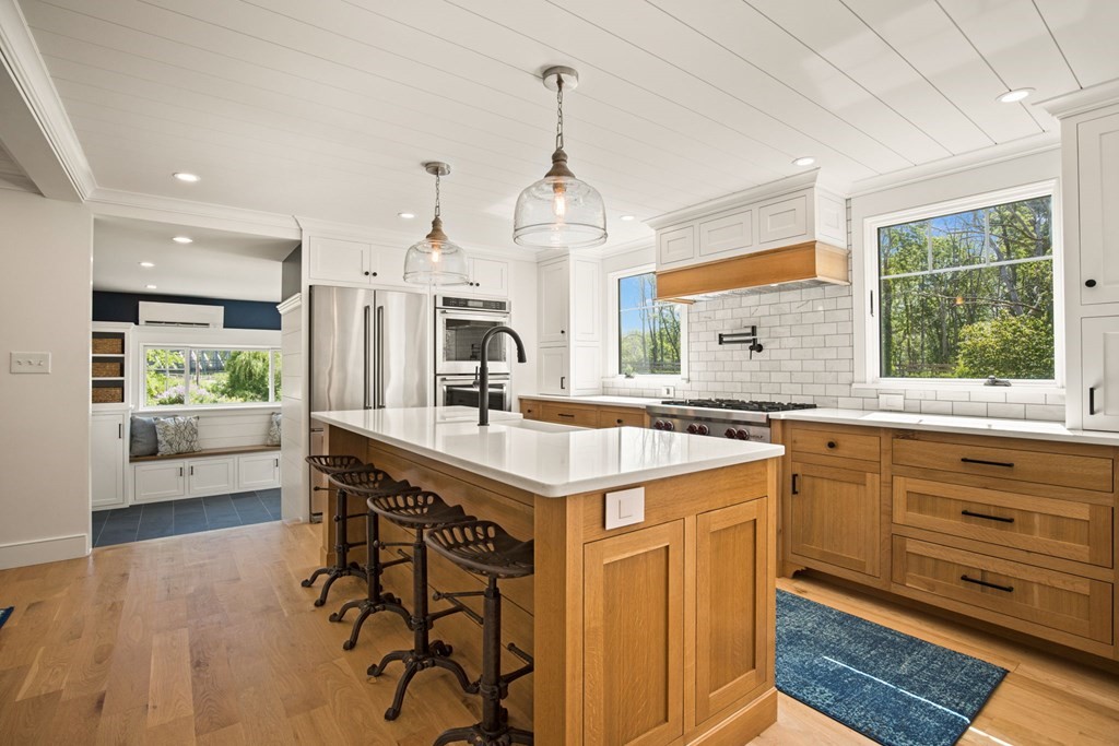1 True Road Salisbury, MA 01952 - Photo 20 of 41 a kitchen with stainless steel appliances granite countertop a sink stove and wooden floor