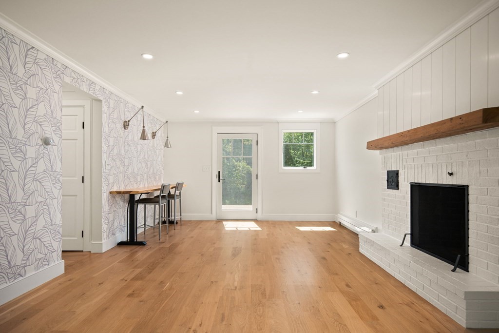 1 True Road Salisbury, MA 01952 - Photo 26 of 41 a view of a livingroom with a fireplace and wooden floor