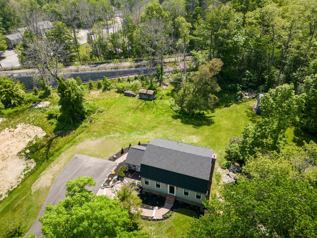 1 True Road Salisbury, MA 01952 - Photo 4 of 41 an aerial view of a house with a yard lake lake and trees in the back