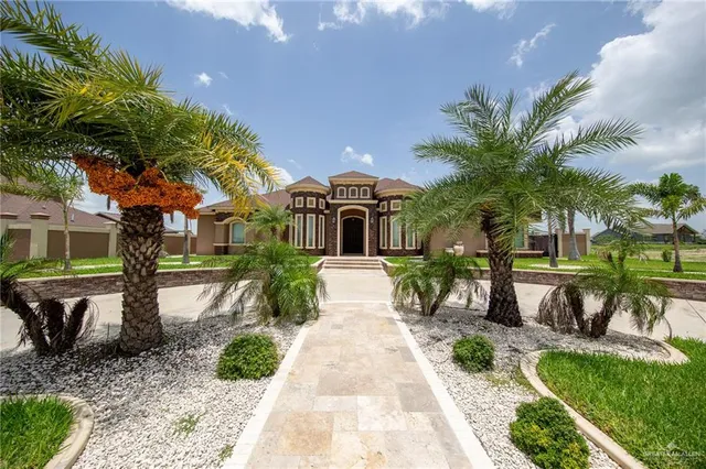 a front view of a house with garden and patio