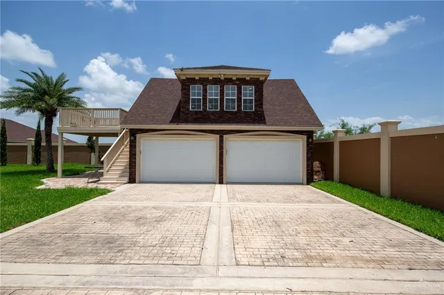 a white house with a yard and a garden