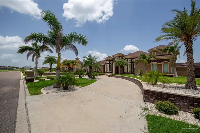 a picture of a yard and front view of a house