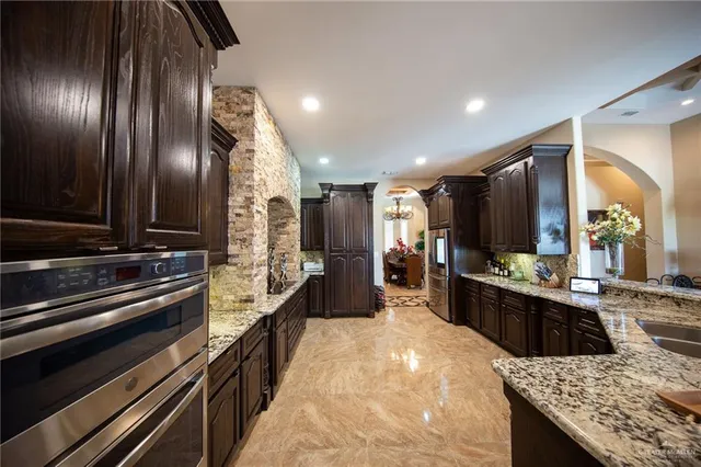 a kitchen that has a table and chairs in it
