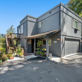 a view of a house with a yard and garden