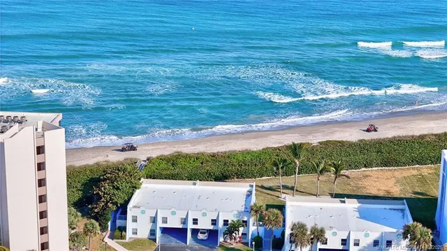 an aerial view of a houses with yard
