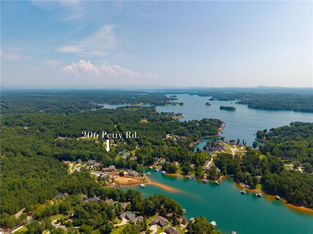 206 Petty Road Seneca, SC 29672 - Photo 45 of 47 Breathtaking aerial views capture a serene lake with expansive waterfront properties nestled among lush trees.