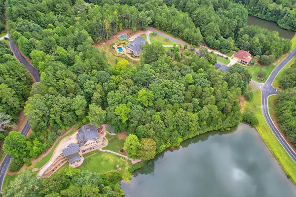 an aerial view of a house with a yard and outdoor seating