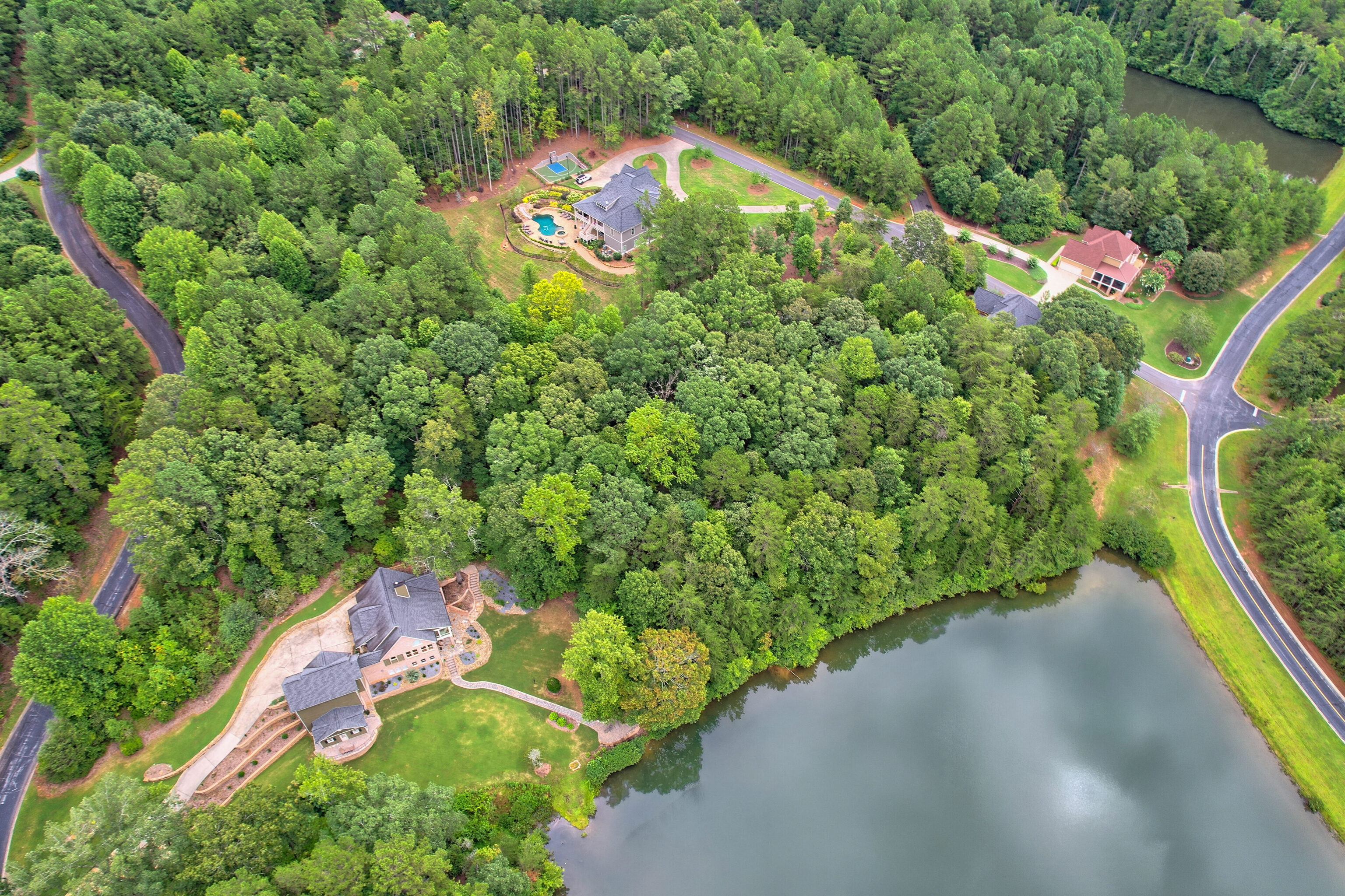 an aerial view of a house with a yard and outdoor seating