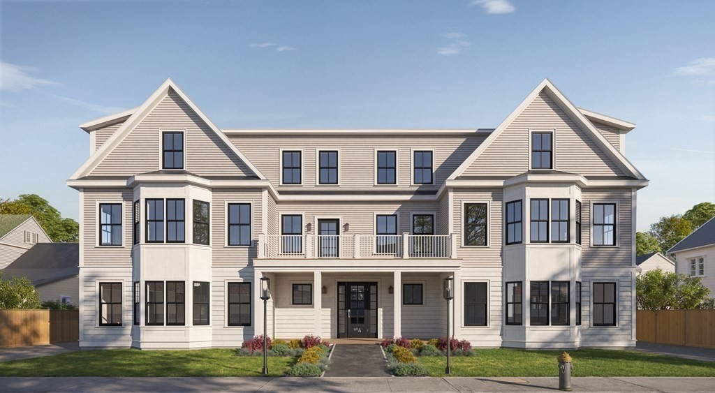 4 Anawan Avenue, Unit 4 Boston, MA 02132 - Photo 1 of 6 a view of residential houses with yard and trees in the background